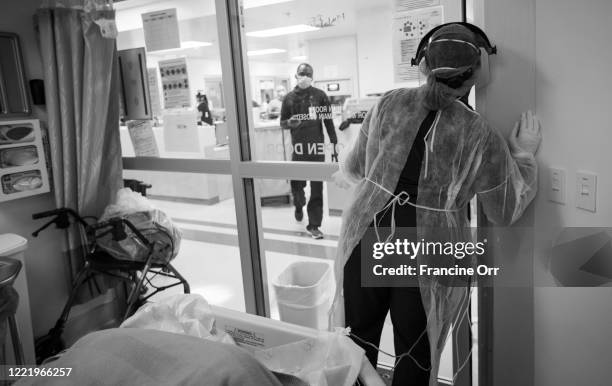 May 6: Wearing her isolation gown, N95, gloves, scrubs, hair covering, and face shield ICU nurse Naomi Okonofua is in the ICU room with a covid19...