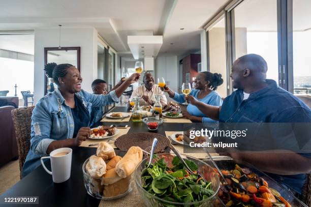 multigenerational family meal - african ethnicity family africa stock pictures, royalty-free photos & images
