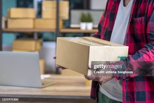 man worker delivery service and working packing box, business owner working checking order to confirm before sending customer in post , shipment online sales - check box bildbanksfoton och bilder