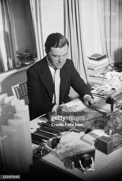 British fashion designer Norman Hartnell at work at his Bruton Street salon in Mayfair, London, November 1938. Original Publication: Picture Post -...