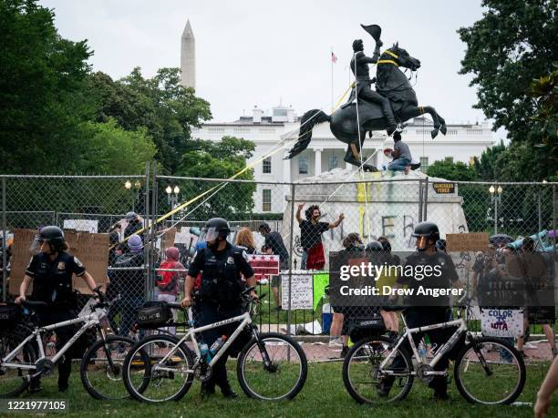 Protesters attempt to pull down the statue of Andrew Jackson in Lafayette Square near the White House on June 22, 2020 in Washington, DC. Protests...