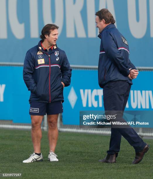 Luke Beveridge, Senior Coach of the Bulldogs and Chris Grant, Bulldogs Football Director chat during the Western Bulldogs AFL training session at...