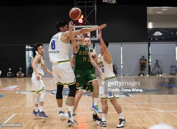 Yu An Chiang of Taiwan Beer attempts the basket under heavy defense during the SBL Finals Game Six between Taiwan Beer and Yulon Luxgen Dinos at Hao...