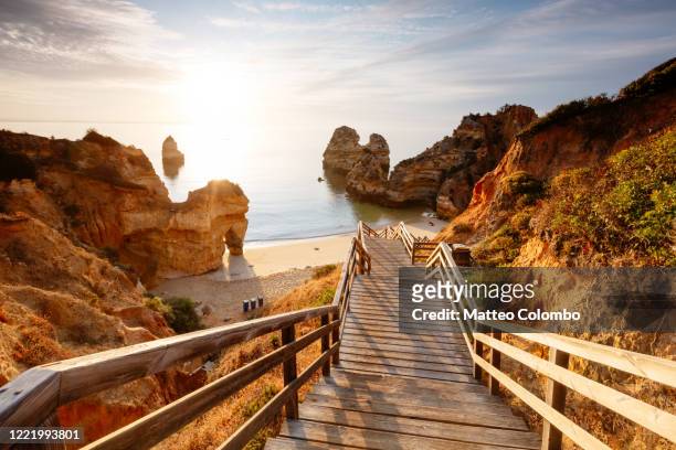 boardwalk to camilo beach at sunrise,  portugal - portugal stock pictures, royalty-free photos & images