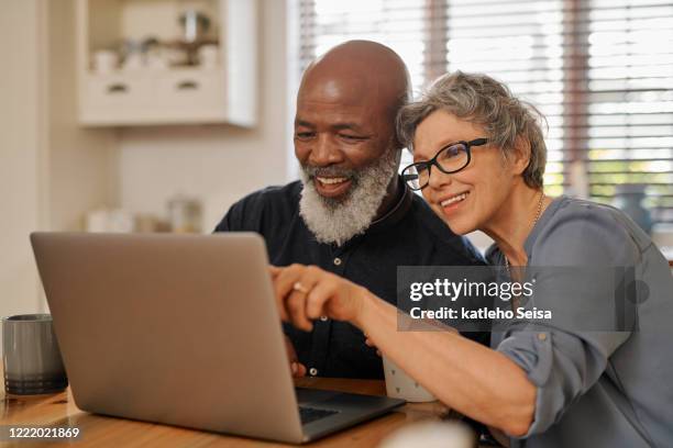 have a look at that over there - senior couple laptop stock pictures, royalty-free photos & images