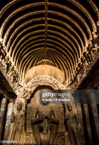 ellora cave 10, a 7th-century buddhist chaitanya hall, seated buddha sculpted with hands in the dharmachakra mudra, aurangabad, maharashtra, india - ajanta caves stockfoto's en -beelden