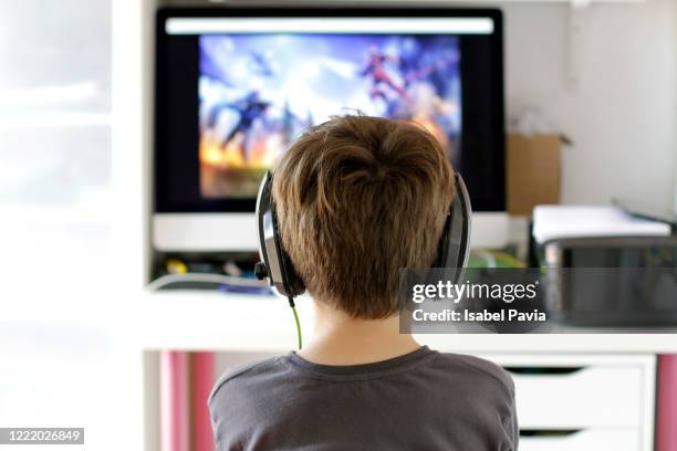 rear view of boy playing video game - back in the game stock pictures, royalty-free photos & images