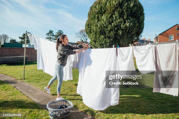 working on household chores - hanging clothes stock pictures, royalty-free photos & images