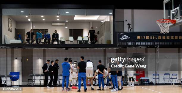 Vips can only watch the game from the window when team Yulon Luxgen Dinos discuss in the empty court during the SBL Finals Game Six between Taiwan...