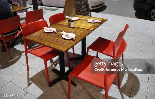 empty table and chairs on sidewalk cafe - modern restaurant exterior stock pictures, royalty-free photos & images