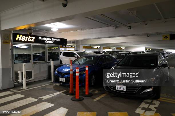 Car sit idle at the Hertz Rent-A-Car rental lot at San Francisco International Airport on April 30, 2020 in San Francisco, California. According to a...