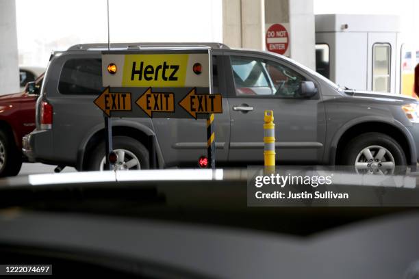 Sign is posted at the Hertz Rent-A-Car rental lot at San Francisco International Airport on April 30, 2020 in San Francisco, California. According to...