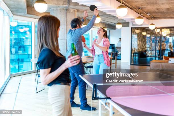colleagues high-fiving at the table tennis match - office ping pong stock pictures, royalty-free photos & images