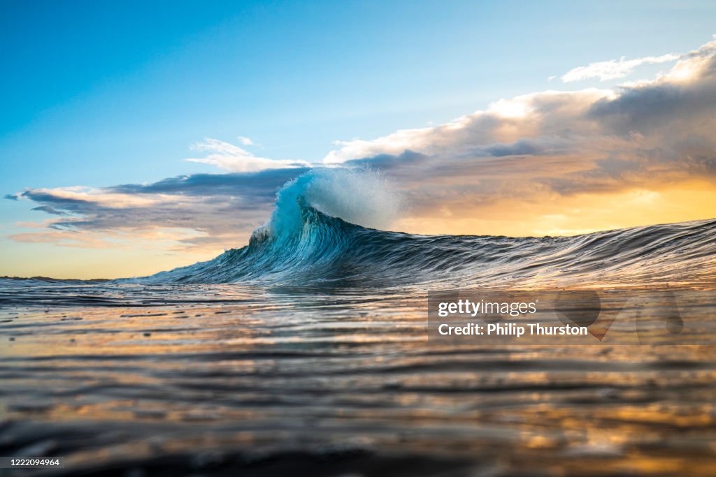 Colourful wave peaking into a flare with sunrise storm