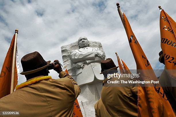 Washington, DC Members of the Alpha Phi Alpha fraternity, in some of the signature clothing, pass beneath a statue of Martin Luther King as they...