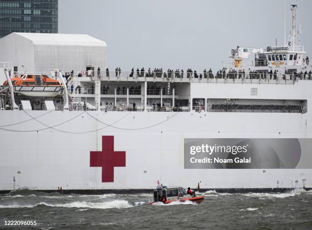 The USNS Comfort hospital ship sails in the Hudson River as it departs New York City after ending its coronavirus duty on April 30, 2020 as seen from...