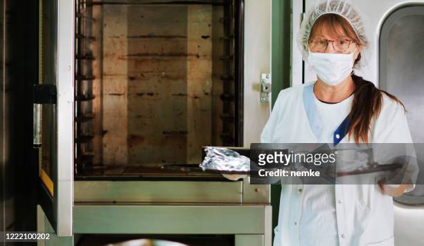 chef working in restaurant kitchen - chef coat stock pictures, royalty-free photos & images