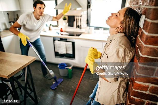 couple cleaning floor in kitchen - housework stock pictures, royalty-free photos & images