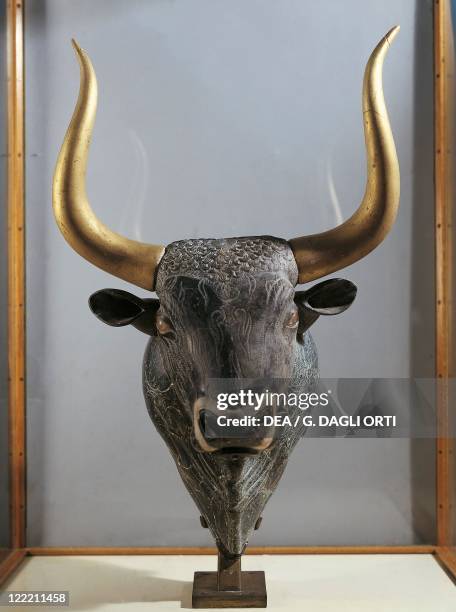 Greek civilization, 16th century b.C. Steatite libation vessel inlaid with rock crystal, mother-of-pearl and jasper, in the shape of a bull's head....