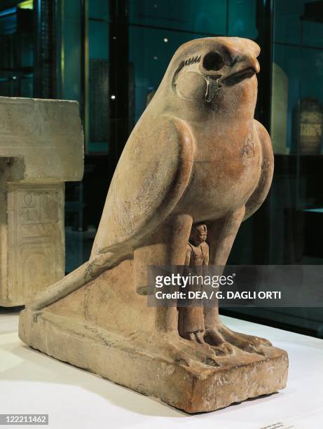 Egyptian civilization, Late Period, Dynasty XXX. Hawk limestone statue protecting King Nectanebo II .