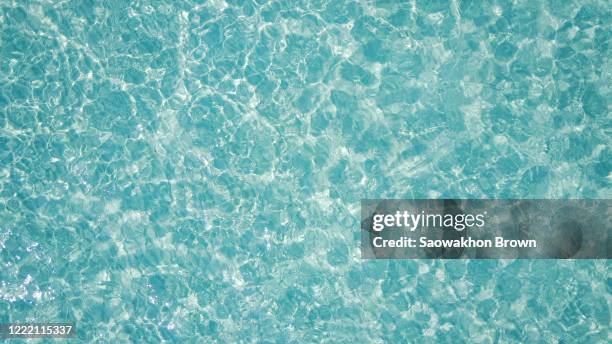 crystal clear water of ocean surface background - blue water ripple overhead stock pictures, royalty-free photos & images