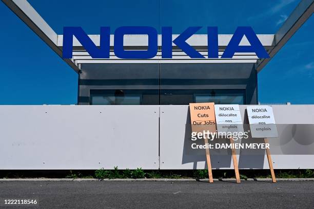 Photograph taken on June 23, 2020 at the plant of the Finland's telecommunition company Nokia in Lanion, western France, shows banners reading...