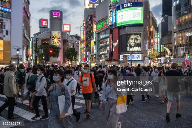 People walk through Shibuya on June 23, 2020 in Tokyo, Japan. Restrictions on businesses in Tokyo were fully lifted recently as the Covid-19...