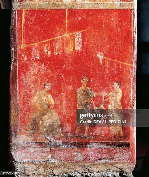 Roman civilization, 1st century A.D. - Pompeii - Fullonica of Veranio Ipseo - Pilaster of the fullers depicting wool-working - A maidservant gives a...