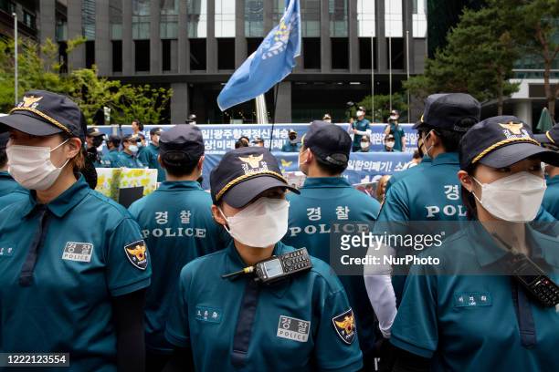 Police block protesters from dispatching each other during The Anti-Abe Anti-Japanese a demonstration at opposite the former Japanese Embassy on June...