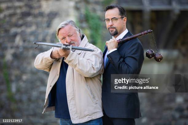 June 2020, North Rhine-Westphalia, Grevenbroich: Jan Josef Liefers , actor, with a morning star with two metal balls and Axel Prahl, actor, with a...