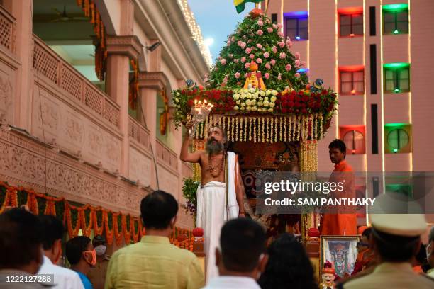 Head priest of Lord Jagannath Mandir, Dilip Das Maharaj , performs a ritual on a chariot next to the idol of Lord Jagnnath at the campus of Lord...