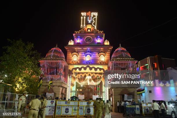 Security personnel keep vigil on the decorated entrance of Lord Jagannath Temple as the annual Rath Yatra procession was cancelled amid concerns over...