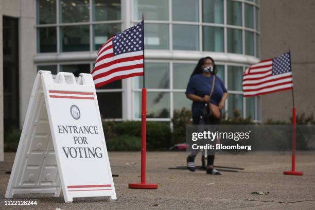 Voter wearing a protective mask leaves a polling location in Louisville, Kentucky, U.S., on Tuesday, June 23, 2020. Voters face the possibility of...