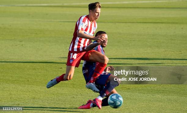 Atletico Madrid's Spanish midfielder Marcos Llorente vies with Levante's Portuguese defender Ruben Vezo during the Spanish league football match Real...
