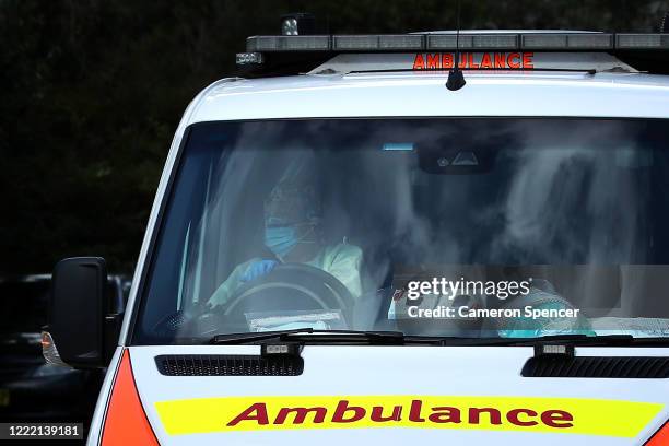 An New South Wales ambulance leaves Newmarch House with a patient on May 01, 2020 in Sydney, Australia. The death toll from a COVID-19 cluster at...