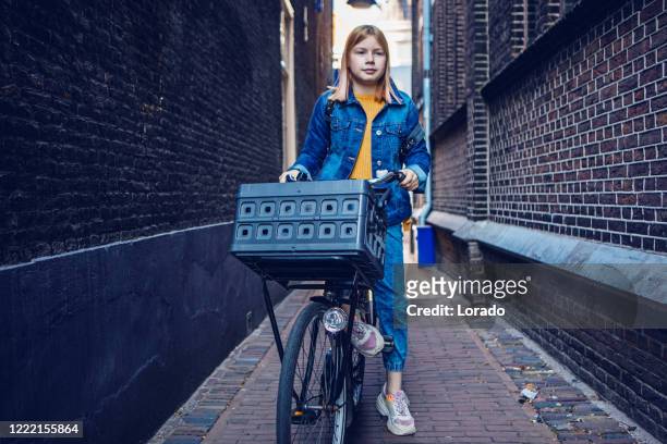 jong meisje dat in een steeg fietst - alleen één meisje stockfoto's en -beelden