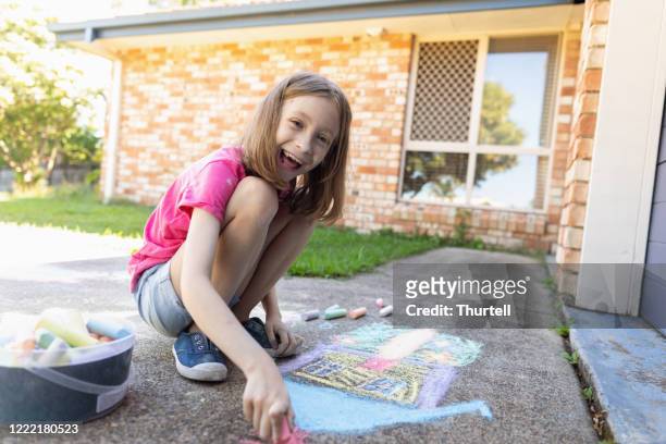 young girl doing chalk art on driveway - 9 hand drawn patterns stock pictures, royalty-free photos & images