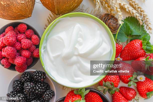 yogurt in a bowl with spoons,healthy breakfast with fresh greek yogurt and strawberry on background - greek yogurt stock pictures, royalty-free photos & images