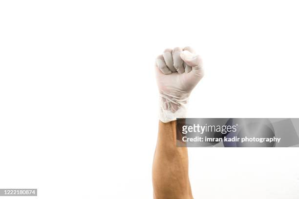 hand using latex glove showing fist or supporter and success sign. - braccio umano foto e immagini stock