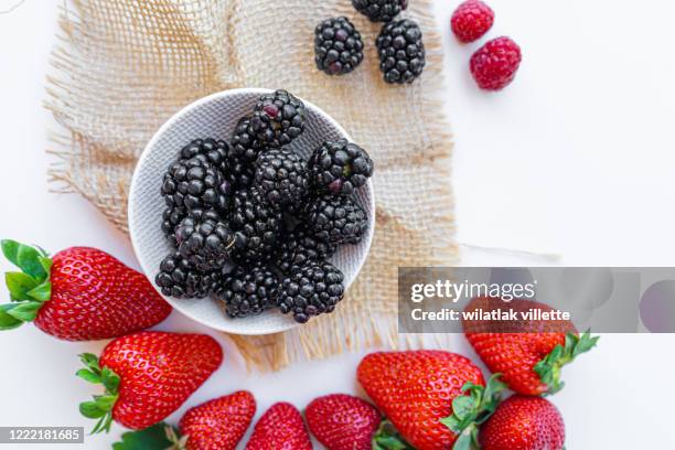 falling wild berries mix, strawberry, raspberry, blackberry, isolated on white background. - strawberry falling stock-fotos und bilder