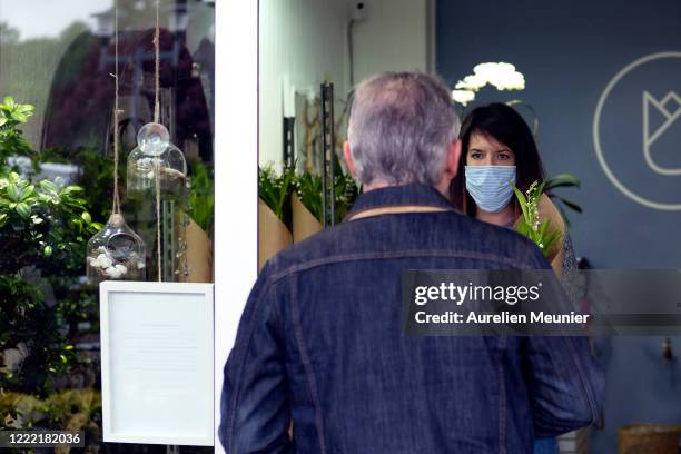 Customer is seen picking up his Lily of the Valley after ordering online in celebration of Labor Day during the Coronavirus pandemic on May 01, 2020...