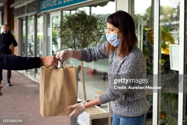 Customer is seen picking up his Lily of the Valley after ordering online in celebration of Labor Day during the Coronavirus pandemic on May 01, 2020...