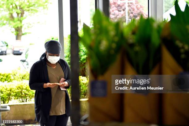 Customer is seen picking up his Lily of the Valley after ordering online in celebration of Labor Day during the Coronavirus pandemic on May 01, 2020...