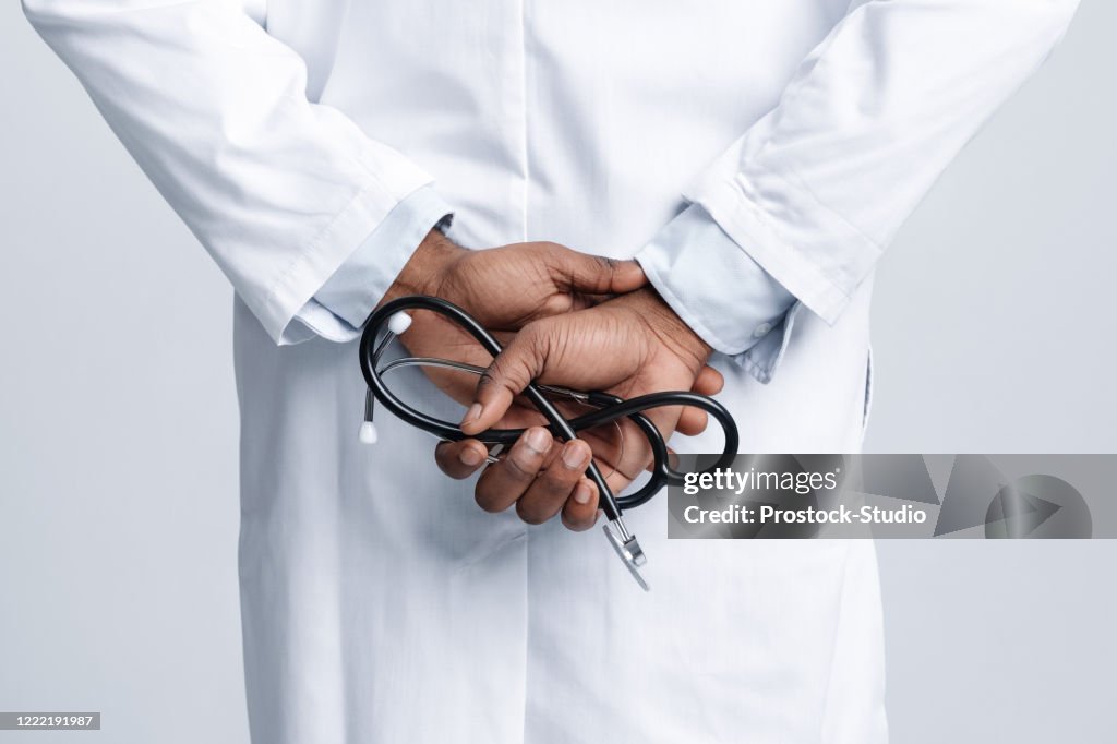Cropped of african american doctor holding arms back with stethoscope