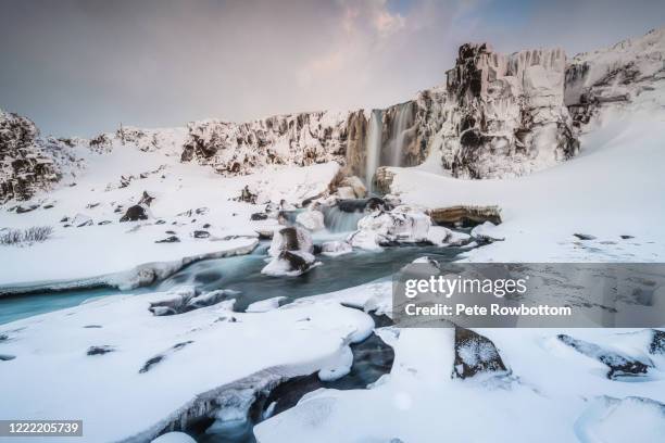 remote waterfall in deep winter - thingvellir national park stock pictures, royalty-free photos & images