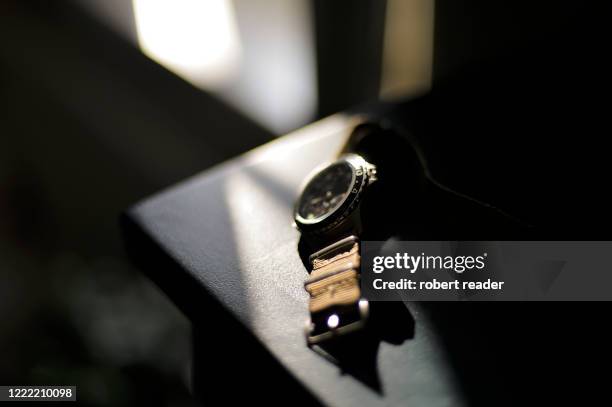 vintage wristwatch on bedside table - luxusuhr stock-fotos und bilder