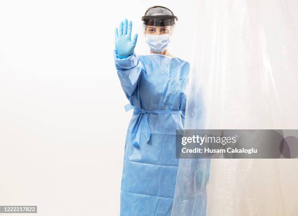 woman doctor behind isolated curtain - apron gloves stock pictures, royalty-free photos & images