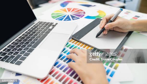graphic designer at work. color swatch samples. artist drawing something on graphic tablet at the office. graphic designer creativity editor ideas designer concept - colour palette stockfoto's en -beelden