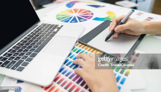 graphic designer at work. color swatch samples. artist drawing something on graphic tablet at the office. graphic designer creativity editor ideas designer concept - graphic designer stock pictures, royalty-free photos & images