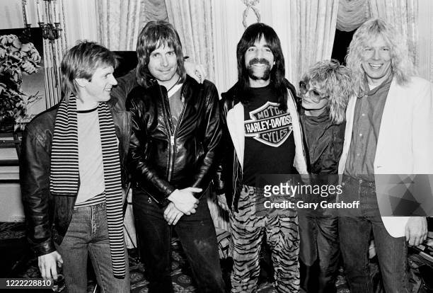 Portrait of American television personalities and MTV VJs Alan Hunter and Nina Blackwood as they pose with members of the fictional Heavy Metal band...